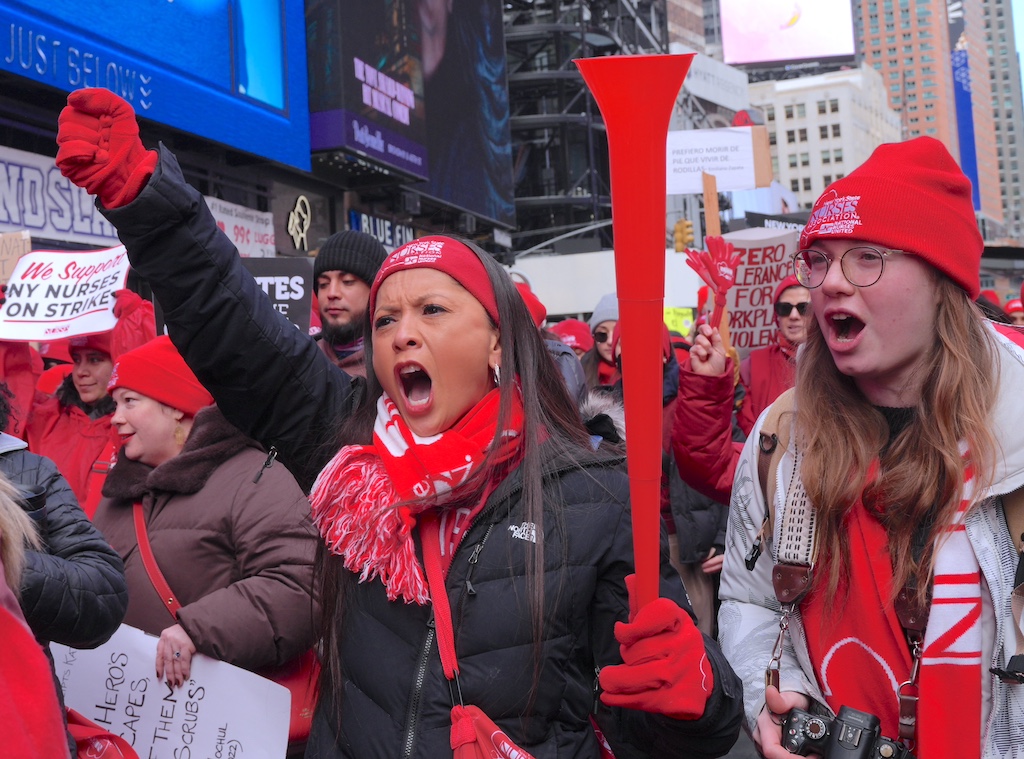 Nurses in a strike flood Times Square in New York City