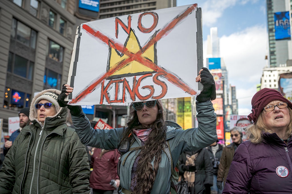 Participant seen holding a sign at the protest. Hundreds of