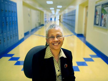 Sylvia Rousseau, seated in a hallway at Crenshaw High School, was the first black principal of Sant