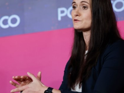 Cait Conley speaking in an interview with a background reading Politico.