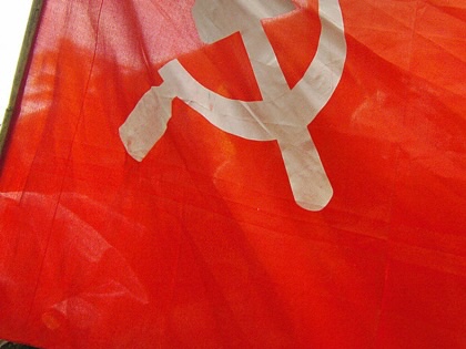 An activist from a Bangladesh leftist party carries the Communist flag during a general strike in Dhaka, on August 20, 2005.