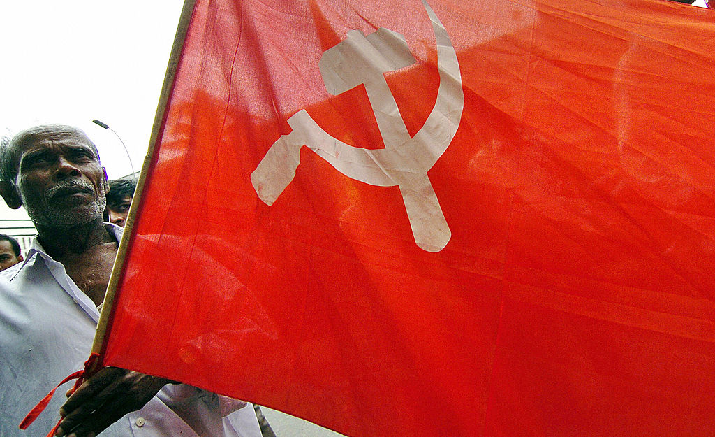 An activist from a Bangladesh leftist party carries the Communist flag during a general strike in Dhaka, on August 20, 2005.