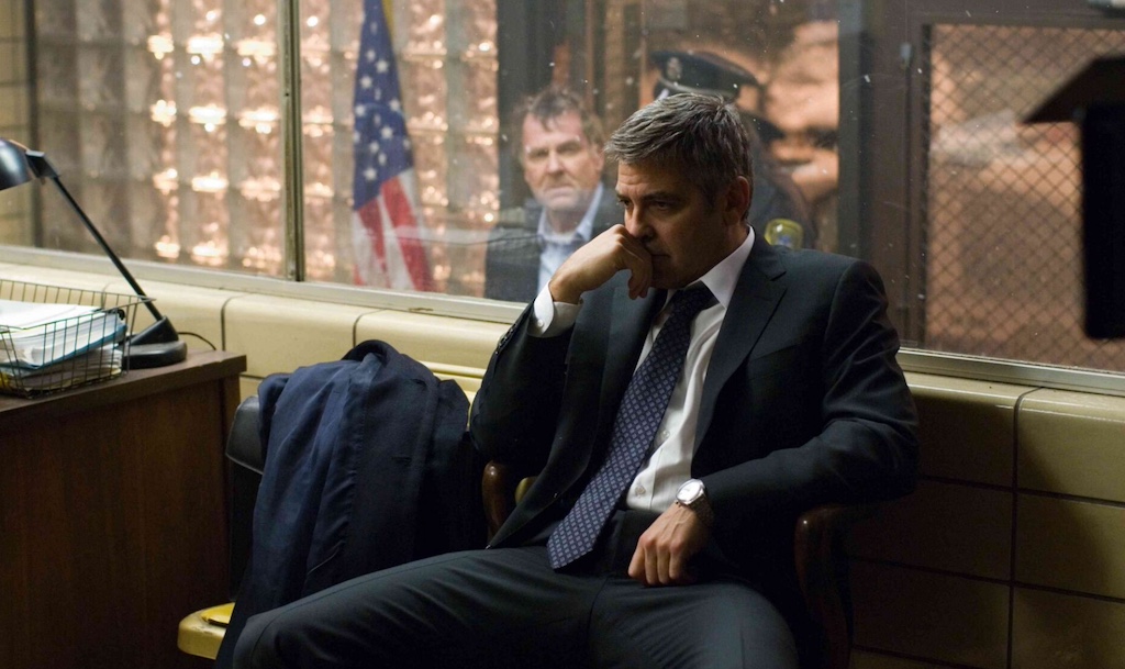 Still from Michael Clayton of George Clooney's character sitting in a chair staring into space.
