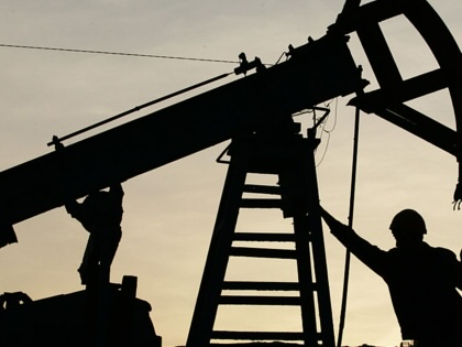 A worker pictured with an oil derrick in Azerbaijan.