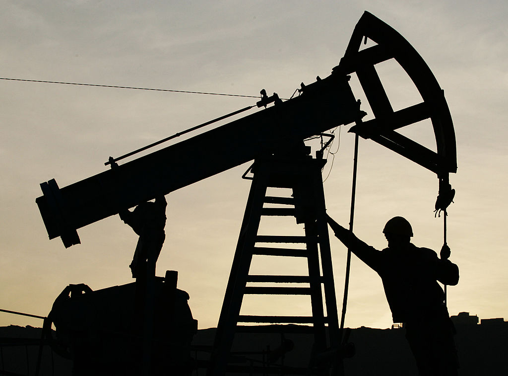 A worker pictured with an oil derrick in Azerbaijan.