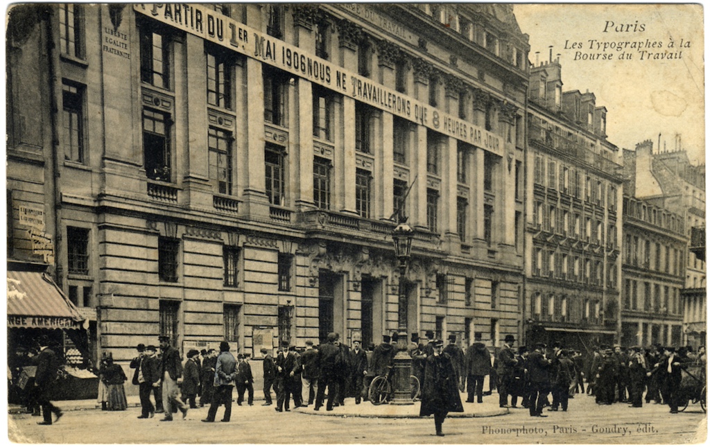 A sepia-colored postcard showing a banner hung on the Labor Exchange Building in France that reads, 