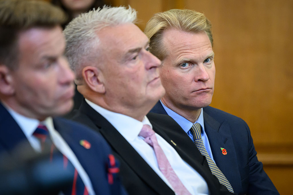Reform UK Chairman David Bull (left) and Reform UK MP for Ashfield Lee Anderson (center) and Reform UK advisor James Orr (right) listen as former Conservative MP Danny Kruger addresses the media during a Reform UK press conference on October 28, 2025, in London, England.