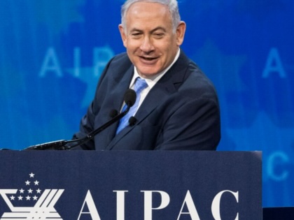 Benjamin Netanyahu stands at a podium that reads "AIPAC."