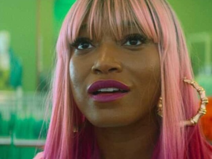 Close up still on actress Keke Palmer as Corvette with pink hair.