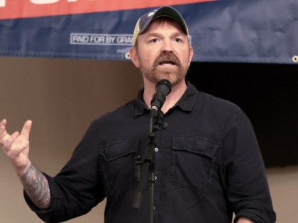 Graham Plater speaking into a microphone while gesturing.