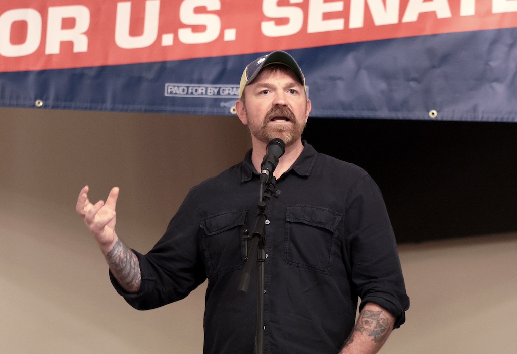 Graham Plater speaking into a microphone while gesturing.