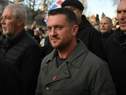 Tommy Robinson standing in a crowd on the street. 
