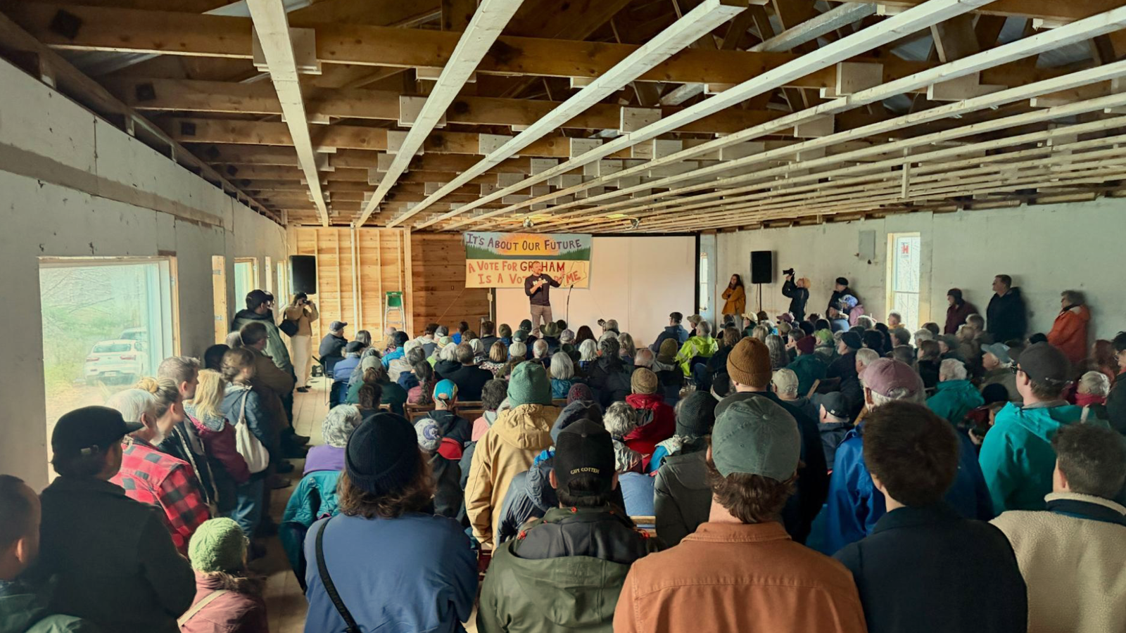 Graham Platner speaks to a crowd in a barn in Appleton, Maine, on May 2, 2026.