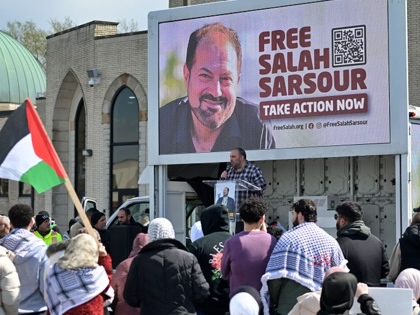 People, a holding portrait of Salah Sarsour, gather outside the Mosque Foundation to demand the release of Sarsour, the president of the Milwaukee Islamic Society and a prominent Palestinian American community leader, who was detained by US Immigration and Customs Enforcement (ICE) agents on March 30, in Bridgeview, Illinois, on April 19, 2026.