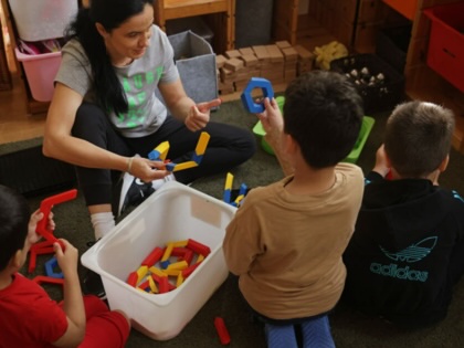 A teacher plays with children at the Kleiner Fratz daycare center in Berlin, Germany.