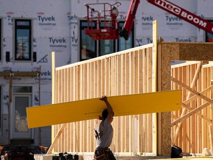 Workers at a construction site of new town houses near the Reservoir Park Recreation Center on April 8, 2026, in Washington, DC.
