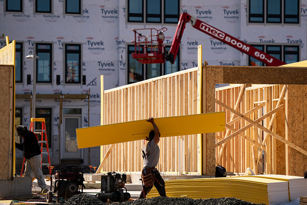 Workers at a construction site of new town houses near the Reservoir Park Recreation Center on April 8, 2026, in Washington, DC.