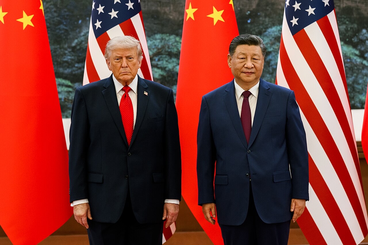 US president Donald Trump and Chinese president Xi Jinping, photographed side by side in front of American and Chinese flags.