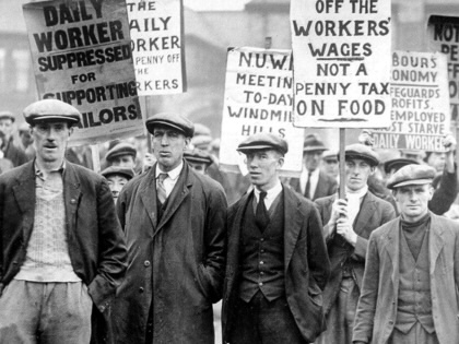 A group of workers holding up placards, one reading, "Not a penny off the workers' wages not a penny tax on food."
