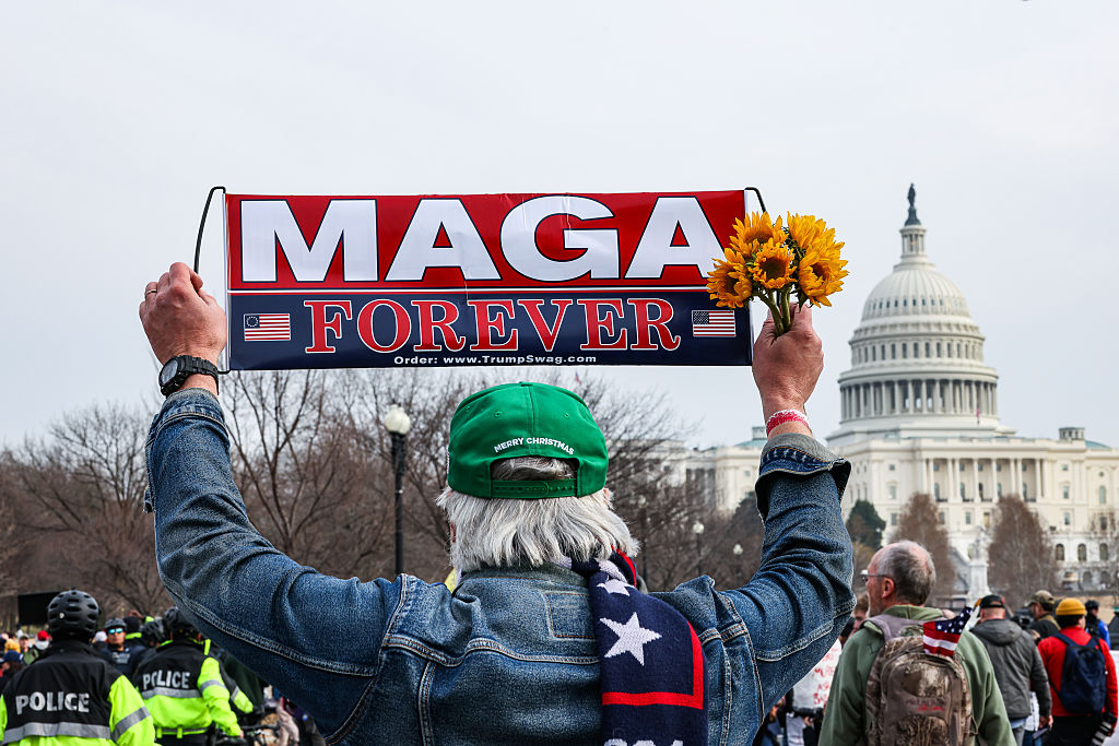 A demonstrator holds a sign that reads "MAGA Forever" outside the US Capitol, marking the fifth anniversary of the riot on January 6, 2021. 