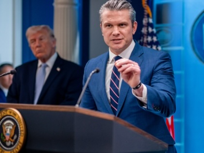 Pete Hegseth speaking at a podium with Donald Trump looking on.