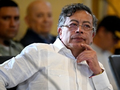Gustavo Petro resting his hand on his chin while sitting at a table. 