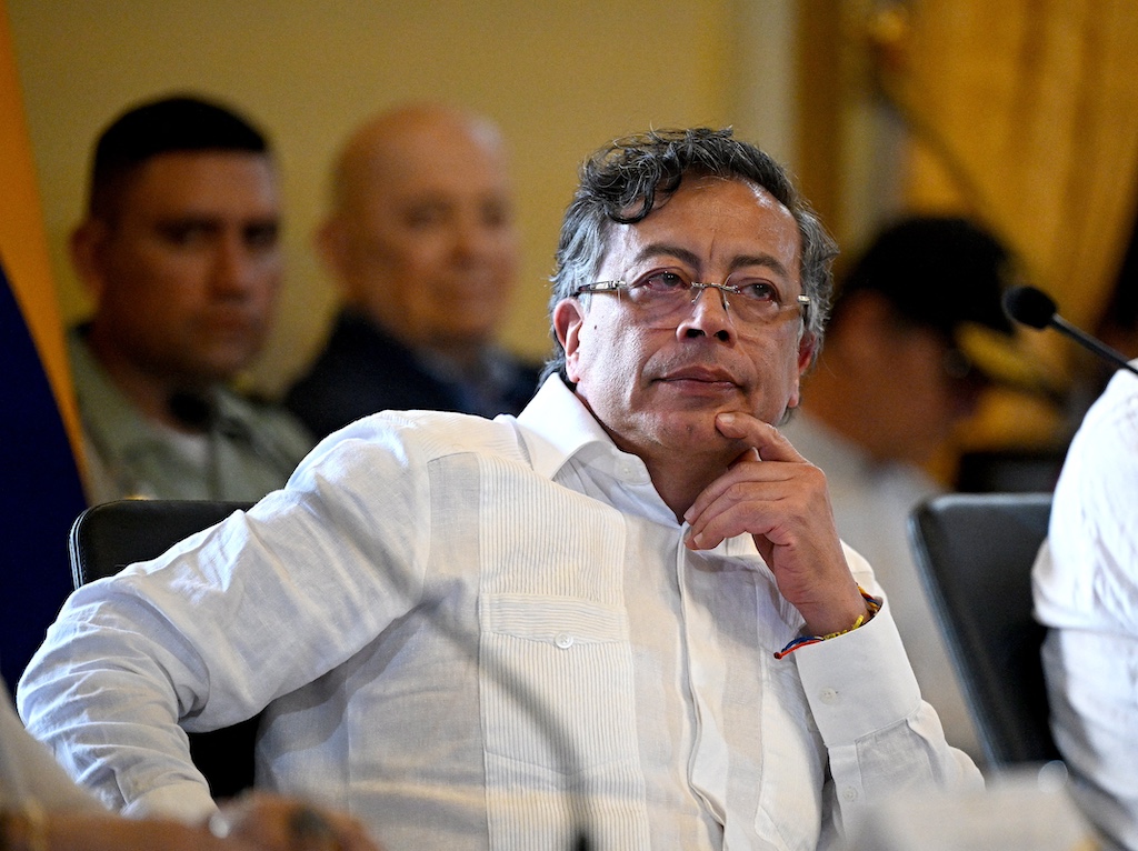 Gustavo Petro resting his hand on his chin while sitting at a table. 