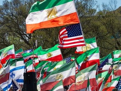 Demonstrators wave pre-1979 Iranian flags, as well as American and Israeli ones, on the National Mall in Washington, DC, on March 29, 2026.