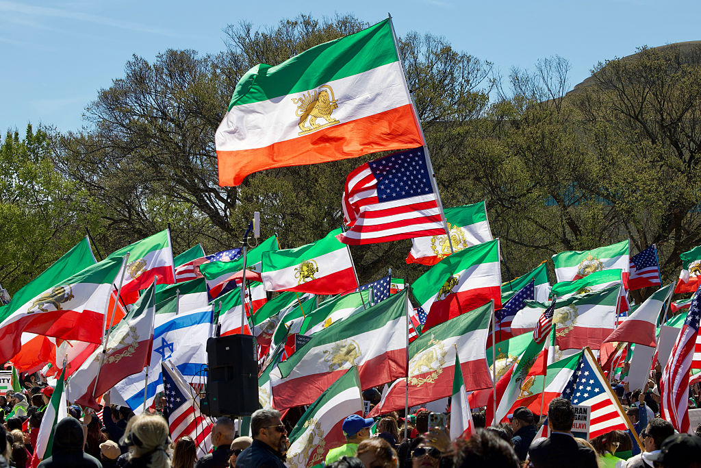 Demonstrators wave pre-1979 Iranian flags, as well as American and Israeli ones, on the National Mall in Washington, DC, on March 29, 2026.