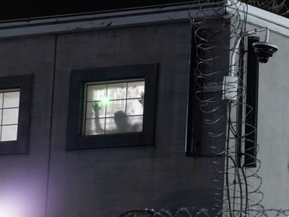 Imprisoned immigrants greet immigration activists from windows as ICE agents and pro-immigration activists face off outside the Delaney Hall Immigration Detention Center Newark, New Jersey. 