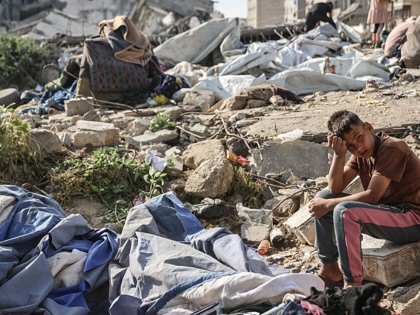 A Palestinian boy sits at the site of an overnight Israeli military strike on structures and tents housing displaced families, killing ten Palestinians, in Gaza City on May 28, 2026.
