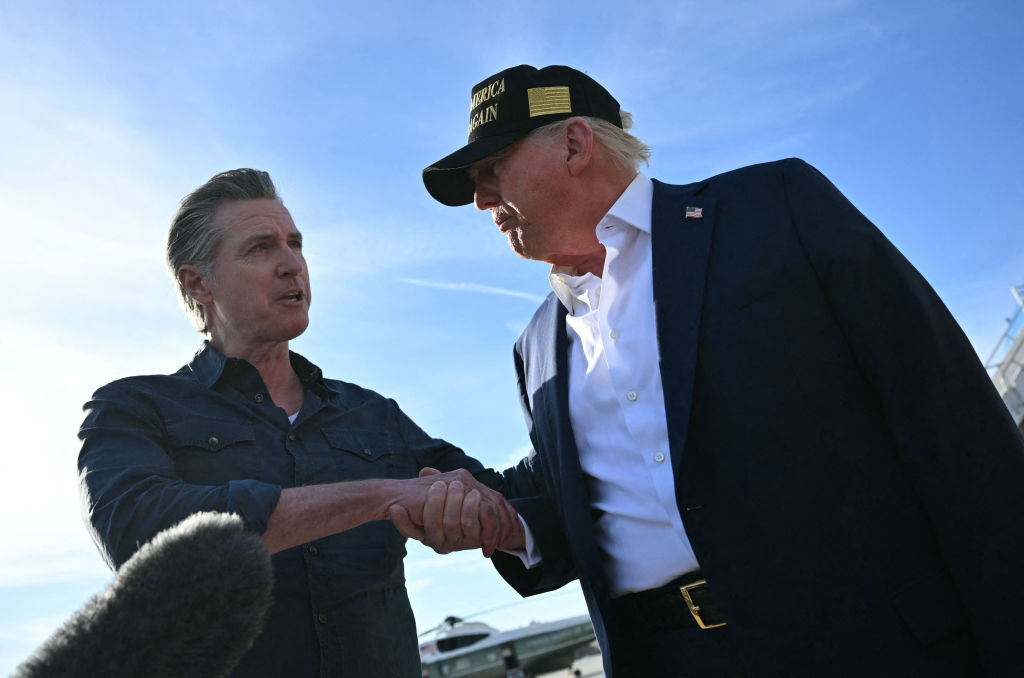 Gavin Newsom shakes hands with Donald Trump. 