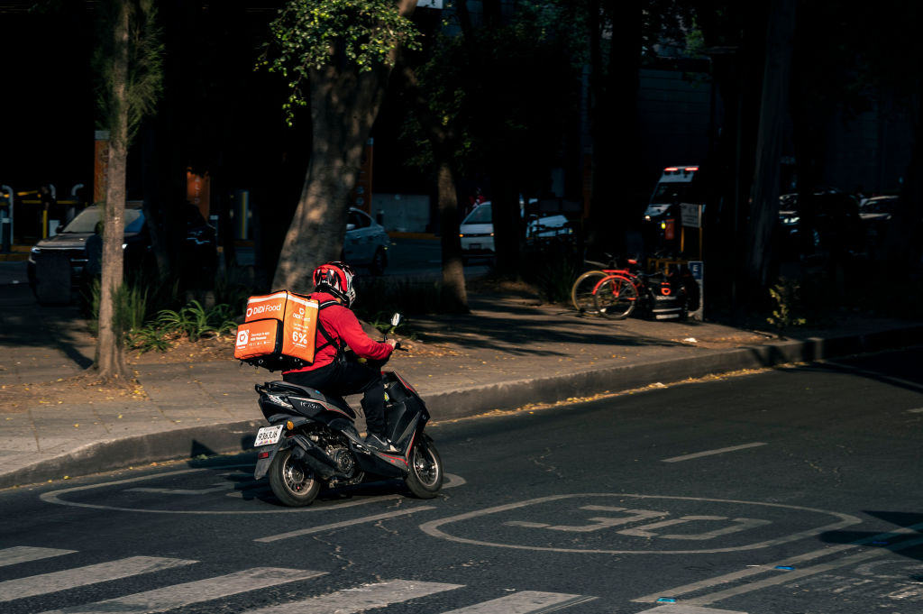App delivery worker rides scooter in Mexico