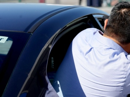 A man gets into an Uber.