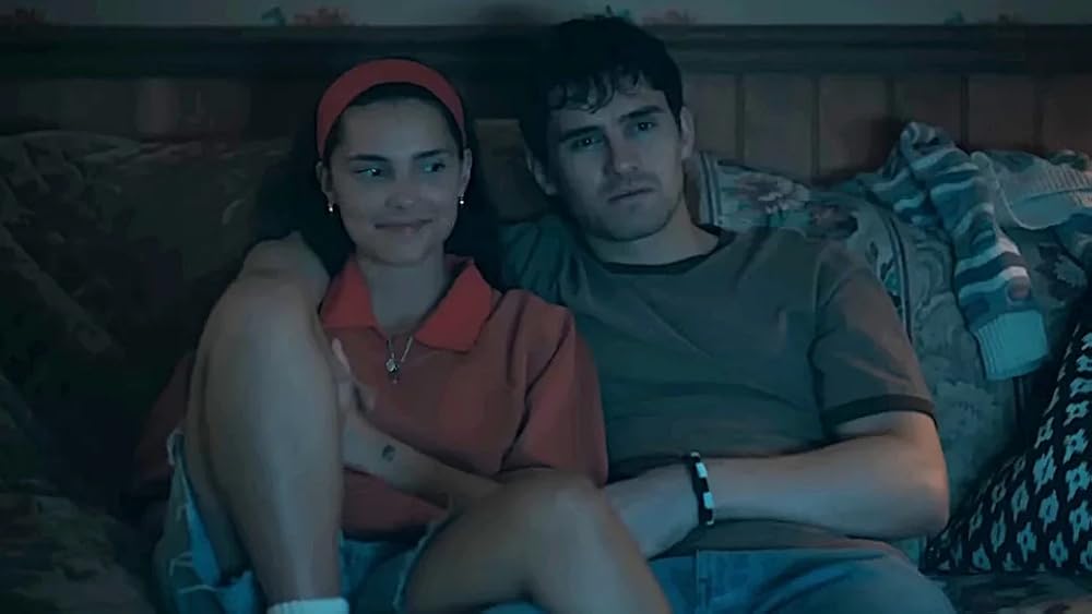 Inde Navarette and Michael Johnston, playing Nikki and Bear in Obsession, snuggle on the couch.