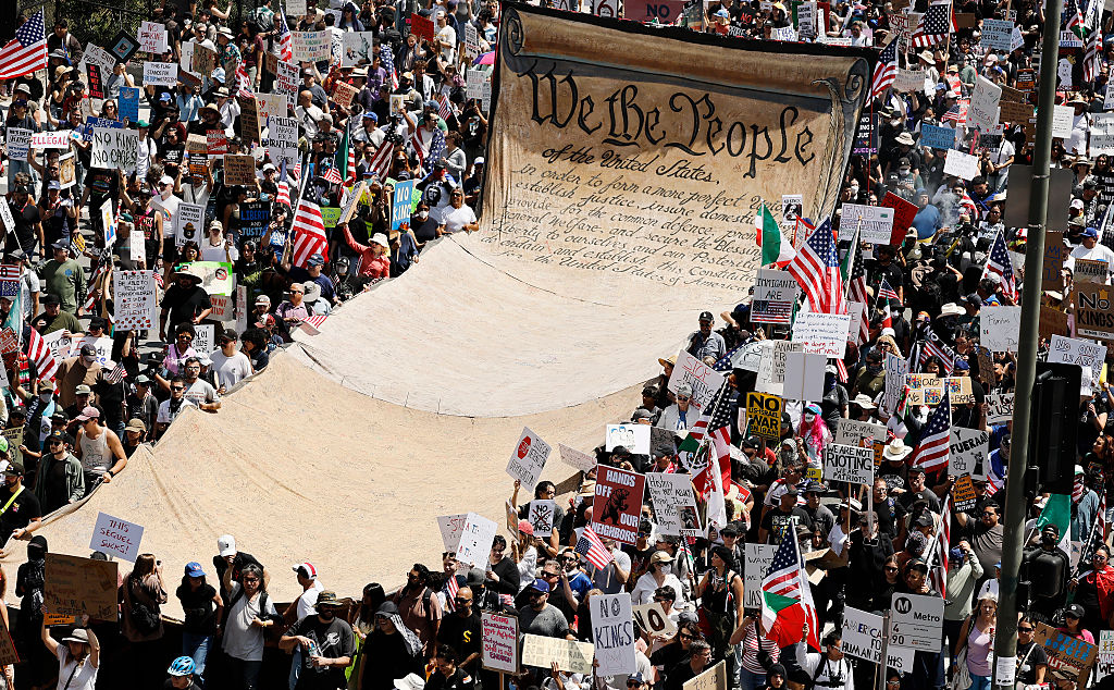 Protesters carry a banner representing the preamble to the US Constitution in Downtown Los Angeles during a “No Kings Day” demonstration against Donald Trump on June 14, 2025.