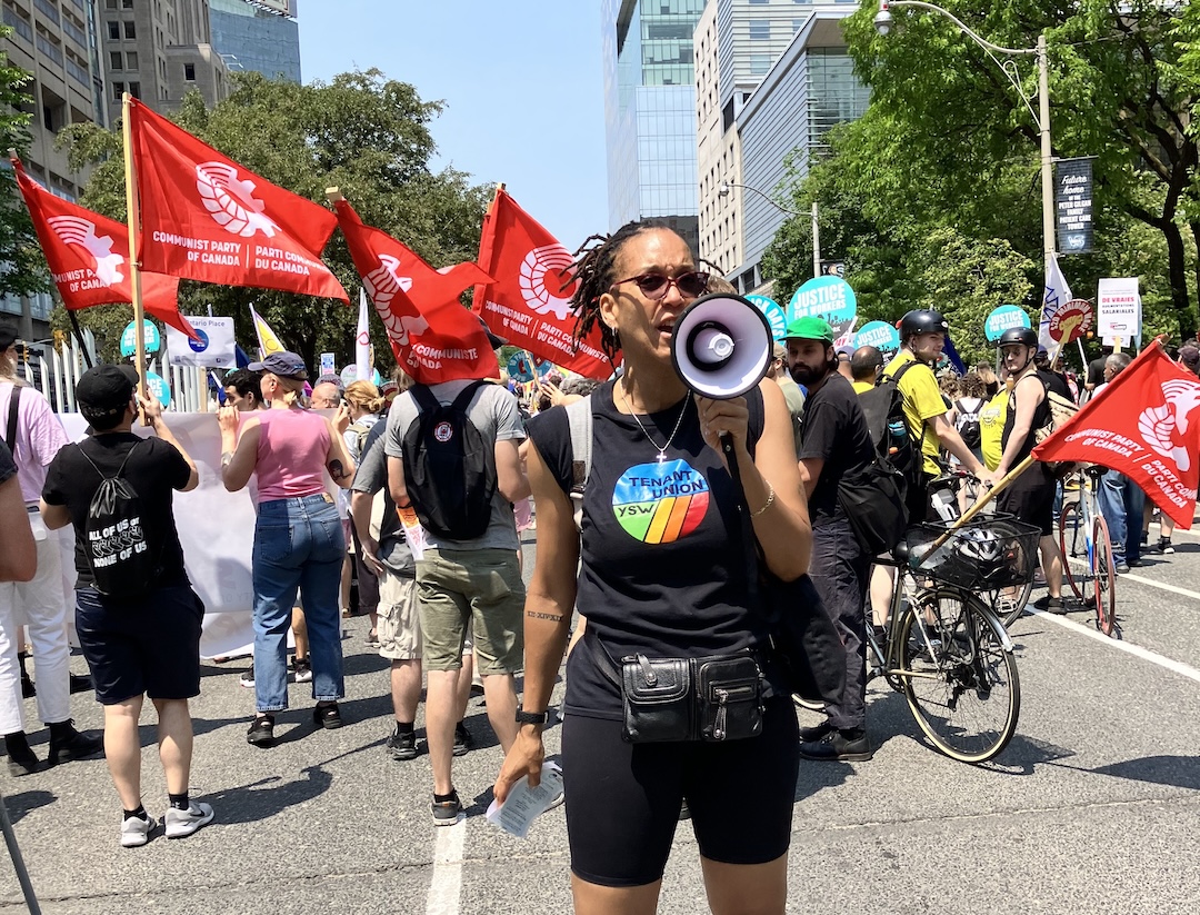 Toronto Tenant Union cochair Sharlene Henry speaks into a bullhorn at a rally.