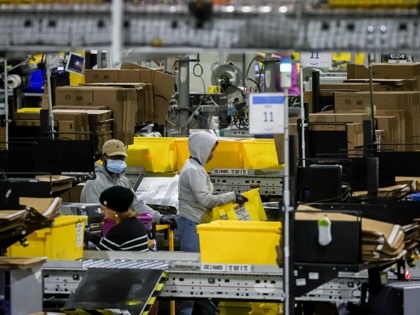 Workers prepare packages for shipping at an Amazon Fulfillment center on Cyber Monday in Robbinsville, New Jersey, on Monday, December 1, 2025.