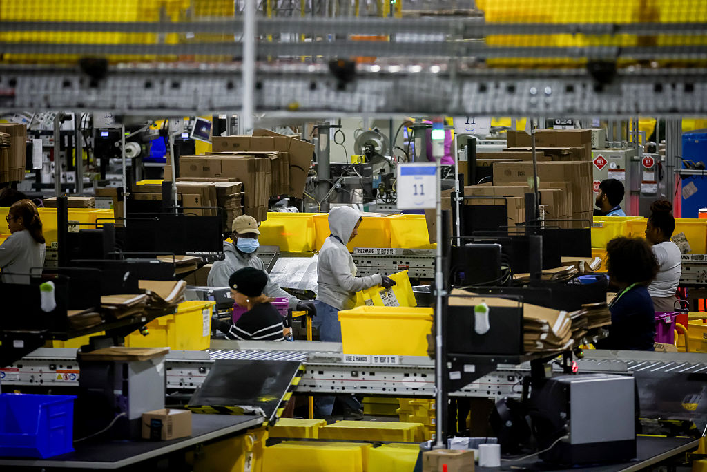 Workers prepare packages for shipping at an Amazon Fulfillment center on Cyber Monday in Robbinsville, New Jersey, on Monday, December 1, 2025.