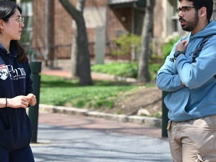 Two students speak on the campus of the University of Pennsylvania, in Philadelphia.