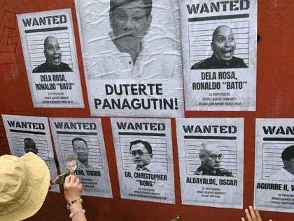 Relatives of drug suspects, who were allegedly illegally killed under orders from former Philippine president Rodrigo Duterte, post portraits of Duterte and his alleged coperpetrators during a rally along a street in Manila on March 11, 2026.