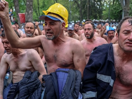 Around ninety miners stage a topless sit-in protest outside Turkey's Energy Ministry to demand unpaid wages in Ankara on April 27, 2026.