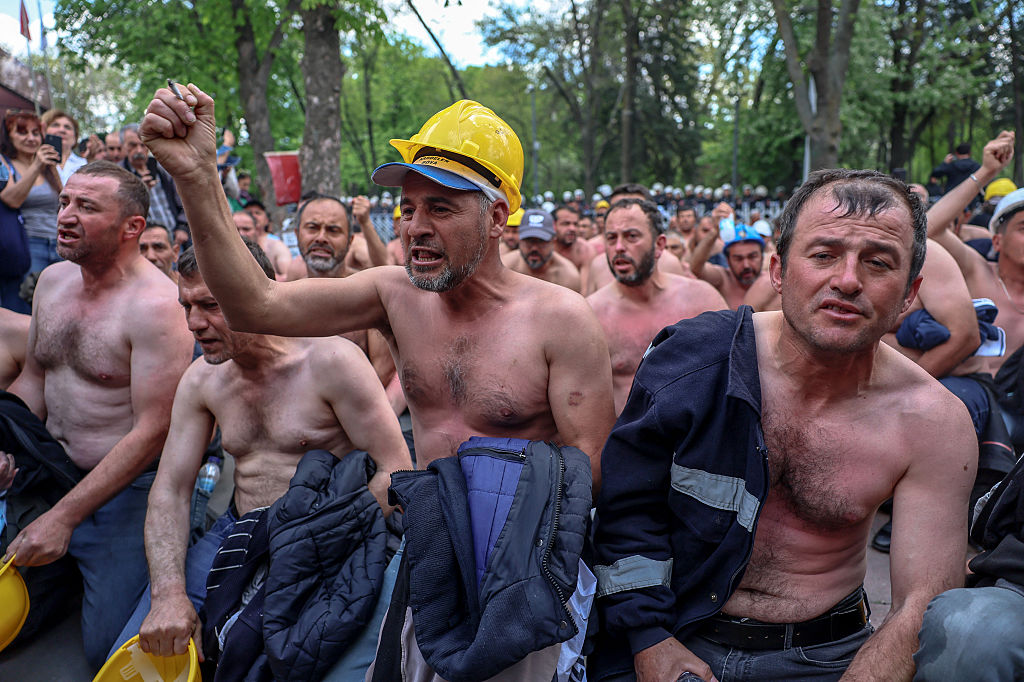 Around ninety miners stage a topless sit-in protest outside Turkey's Energy Ministry to demand unpaid wages in Ankara on April 27, 2026.
