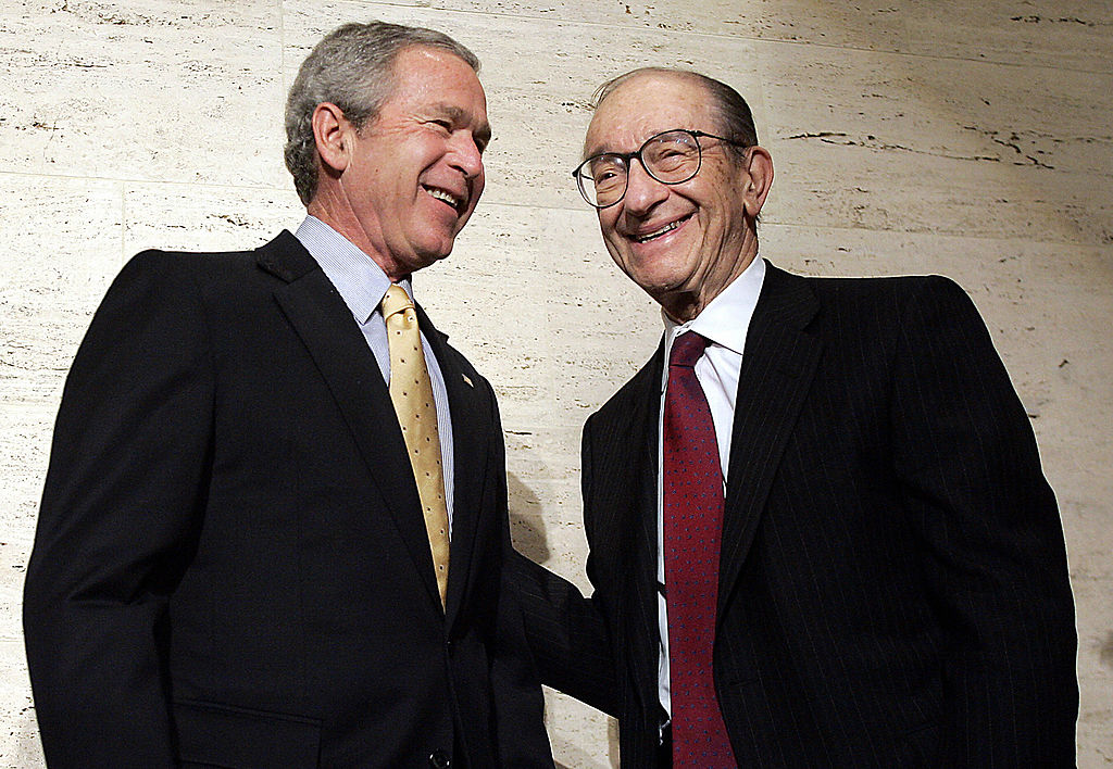 George W. Bush smiles with retired Federal Reserve Chairman Alan Greenspan  in Washington, DC, February 6, 2006. 