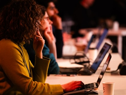 Attendees watch a demonstration of Anthropic PBC's Claude Code software at a conference in London.