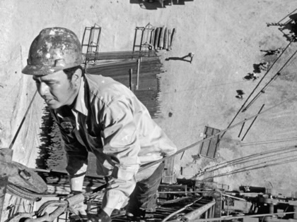 A roughneck oil worker works atop a wildcat oil drilling rig without safety equipment in the oll fields of southeast New Mexico, 1978.