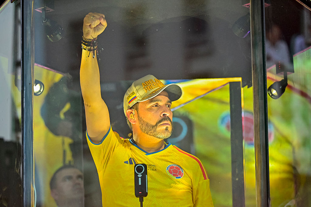 Colombia's presidential candidate Abelardo de la Espriella of the Salvadores de la Patria movement gestures as he speaks to supporters behind bulletproof glass during a campaign rally in Cartagena, Colombia, on June 9, 2026.