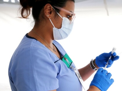 A nurse prepares a dose of a vaccine at a clinic in Los Angeles, California, on March 25, 2021.