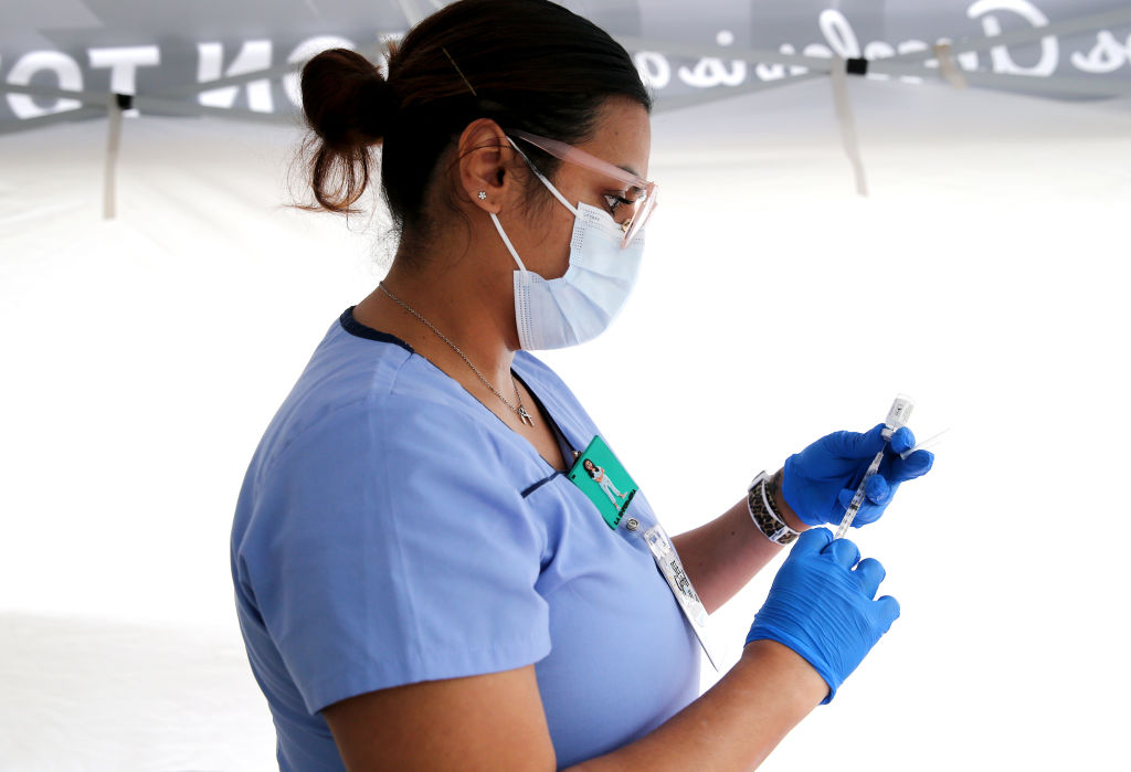 A nurse prepares a dose of a vaccine at a clinic in Los Angeles, California, on March 25, 2021.