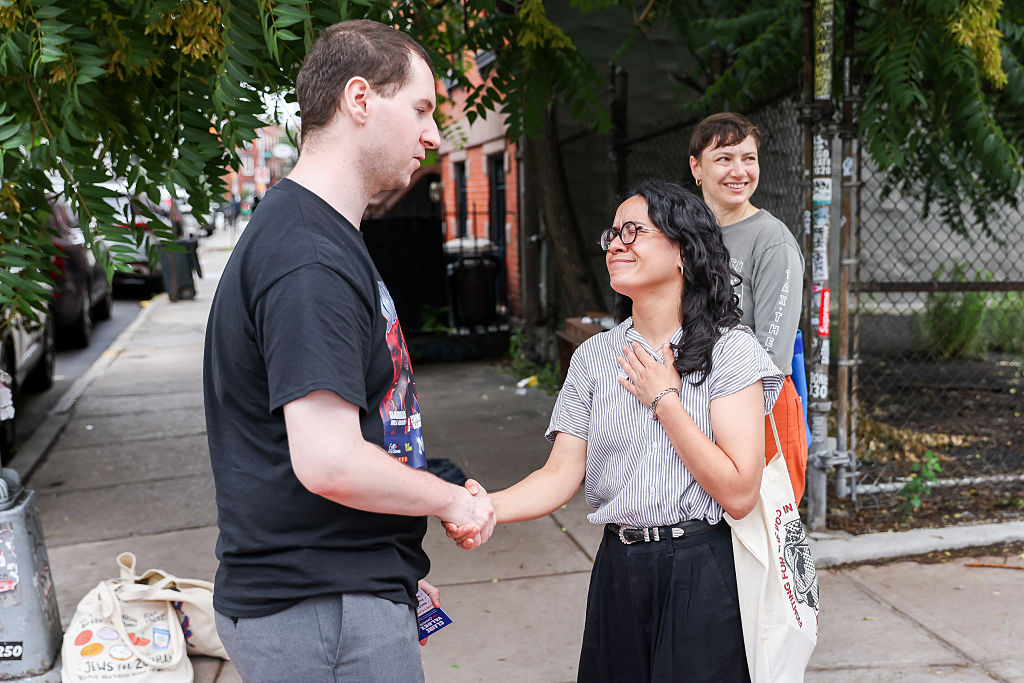 Claire Valdez speaks with voters outside a polling location at PS 84 during a primary election in New York on June 23, 2026.